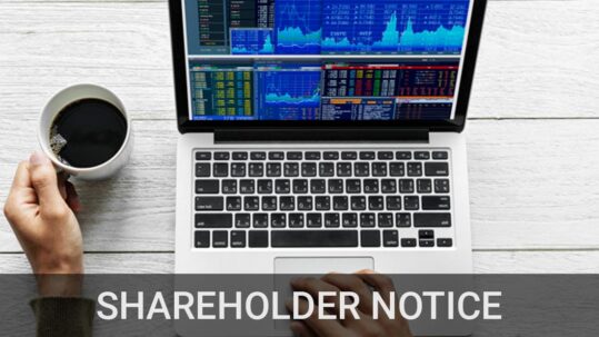 Image of a hand holding a mug with coffee and a laptop on a desk, with text that reads Shareholder Notice.